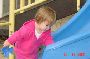 Lia at playground, blue slide.jpg